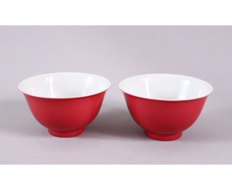 A PAIR OF 19TH / 20TH CENTURY CHINESE RUBY RED GLAZED PORCELAIN TEA BOWLS, with a ruby red / pink glaze, the base with six ch