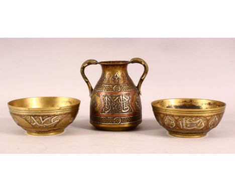 A 19TH CENTURY CAIROWARE TRIO - comprising two small inlaid bowls and an inlaid twin handle vessel, each item inlaid with sil