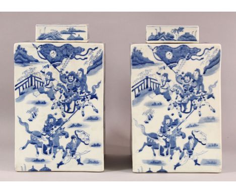 A LARGE PAIR OF CHINESE BLUE &amp; WHITE SQUARE FORMED CADDY &amp; COVERS, each decorated with scenes off figures upon horseb