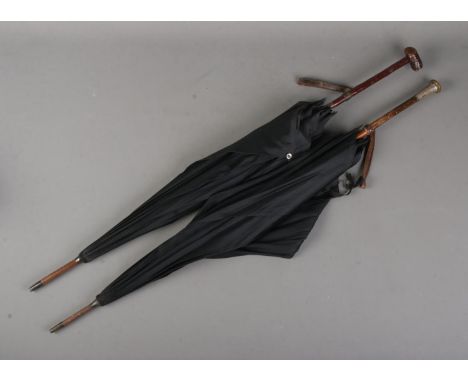 Two vintage parasols to include example featuring silver mounted handle (hallmark indistinct).  Both with small tears/holes. 