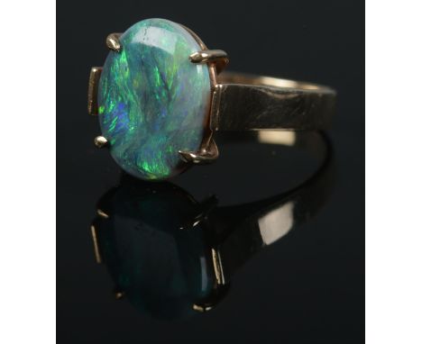 A 9ct gold opal doublet ring. Size of stone approximately 1.5cm x 1cm. Size K 1/2. 3.6g.  