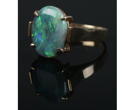 A 9ct gold opal doublet ring. Size of stone approximately 1.5cm x 1cm. Size K 1/2. 3.6g.  