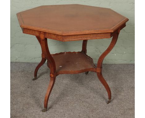 A large Edwardian mahogany inlaid table with shaped legs united by a lower tier shelf on brass castors.Hx77cmWx91cm  