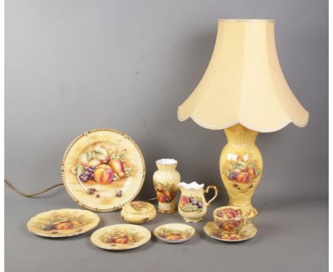 A collection of Aynsley Orchard Gold ceramics to include table lamp, milk jug, plates, small vase, etc. Approx. 9 pieces.  