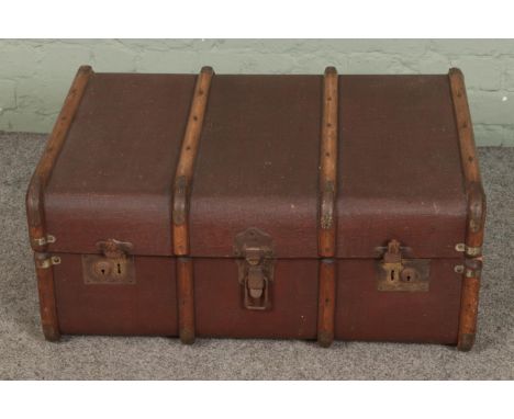 A vintage wooden bound steamer trunk.  