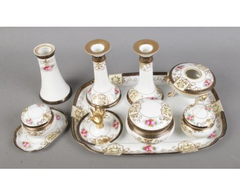 A Noritake dressing table set featuring pair of candlesticks, trinket boxes, tray, etc.  