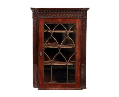 GEORGE III MAHOGANY HANGING CORNER CABINET  18TH CENTURY   in the Chippendale style, the moulded cornice above a blind fret c