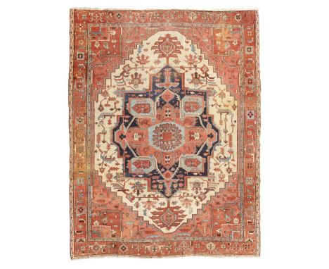 SERAPI CARPET  NORTHWEST PERSIA, LATE 19TH CENTURY   the ivory field with large indigo, blue and pink medallion, pink and red