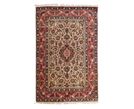 ISFAHAN CARPET  CENTRAL PERSIA, MID/LATE 20TH CENTURY   the cream field with indigo medallion, within pink palmette and vine 