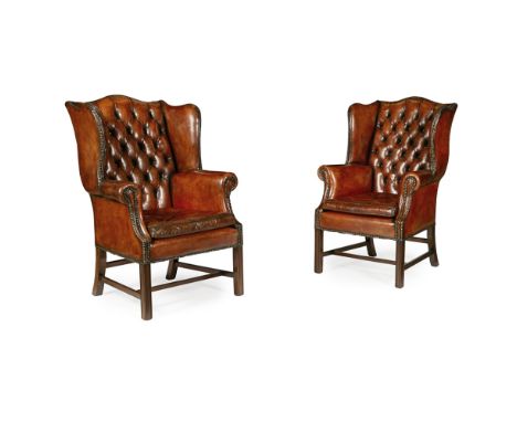 PAIR OF GEORGIAN STYLE LEATHER WING ARMCHAIRS  MODERN   in brown button upholstered leather, the arched backs above loose cus