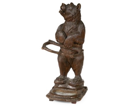 BLACK FOREST CARVED BEAR STICK STAND  19TH CENTURY   the figure with glass eyes and holding a stick holder while standing on 