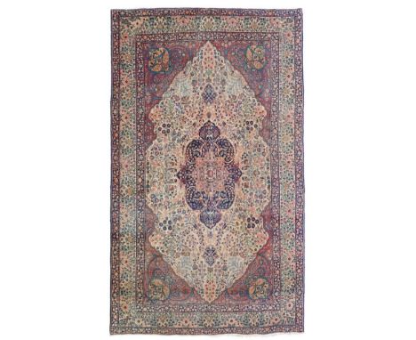 KIRMAN CARPET  CENTRAL PERSIA, LATE 19TH/EARLY 20TH CENTURY   the camel field with indigo and rose medallion, red spandrels, 