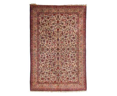 KASHAN CARPET  CENTRAL PERSIA, MID/LATE 20TH CENTURY   the ivory field with allover palmette and scrolling vine pattern, with