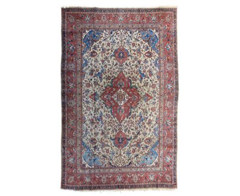 TABRIZ CARPET  NORTHWEST PERSIA, LATE 19TH/EARLY 20TH CENTURY   the camel field with red medallion, blue spandrels, within re