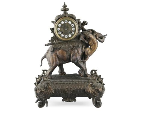 FRENCH PATINATED SPELTER MANTEL CLOCK  LATE 19TH/ EARLY 20TH CENTURY   depicting an elephant carrying a howdah being attacked