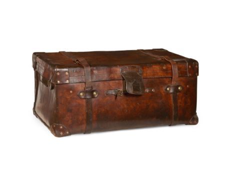 LARGE EDWARDIAN LEATHER AND COPPER STUDDED TRUNK  EARLY 20TH CENTURY   with a hinged cover and twin straps, outlined in large