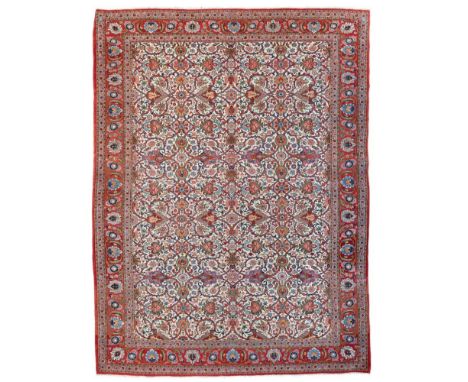 QUM CARPET  CENTRAL PERSIA, 20TH CENTURY   the ivory field with allover palmette and vine lattice pattern, within red palmett
