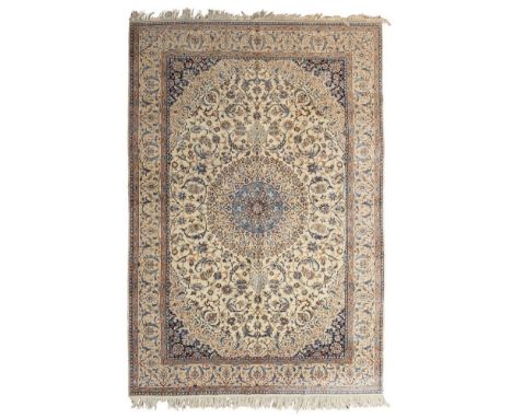 ISFAHAN PART SILK CARPET  CENTRAL PERSIA, MID/LATE 20TH CENTURY   the cream field with blue medallion, indigo spandrels, with
