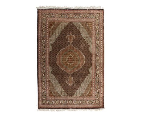 TABRIZ PART SILK CARPET  NORTHWEST PERSIA, MID/LATE 20TH CENTURY   the indigo field with olive and beige medallion, similar s