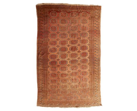 TEKKE CARPET  TURKMENISTAN, LATE 19TH/EARLY 20TH CENTURY   the rust brown field with four columns of fourteen guls, within mu