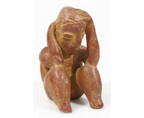 An Inca style unglazed pottery figure, in crouched position with hands to the head, unmarked, 12cm high.