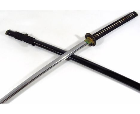 A 20thC Japanese samurai sword and black lacquer scabbard, with turned material hanger and pierced material handle with elabo