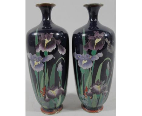 A pair of early 20thC Japanese enamel vases, each with shouldered form, decorated with flowers on a purple ground on circular