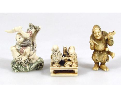 An early 20thC Japanese netsuke, of a beaded gentleman holding a dagger picked out in colours, signed, 6cm high, and two othe