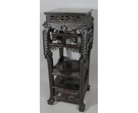 A 19thC Chinese urn stand, probably zitan wood, the square moulded top centred with a section of liver coloured marble, set i