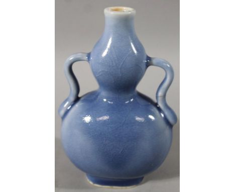 A Chinese porcelain double gourd vase, with serpentine handles and oval foot, overall decorated in blue with dark blue Qianlo