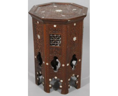 A 20thC Indian hardwood and mother of pearl finish plant stand, the octagonal top raised on pierced supports, 48cm high, 34cm
