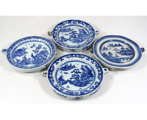 Four Chinese export blue and white porcelain food warmers, the first decorated with birds, flowers, trees and buildings, anot