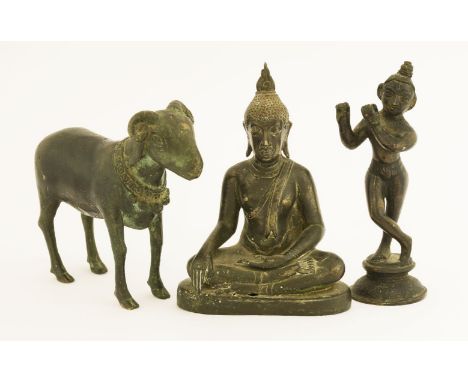 Three Indian bronzes, a pipe-playing figure, lacking pipe, 16cm high, a seated Buddha, 16cm, and a goat, 18cm long (3)