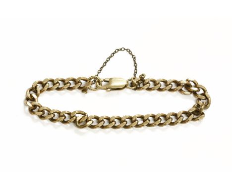 A 9ct gold curb bracelet, 6.6mm wide with a lobster claw clasp and safety chain, hallmarked 9ct gold 18.29g