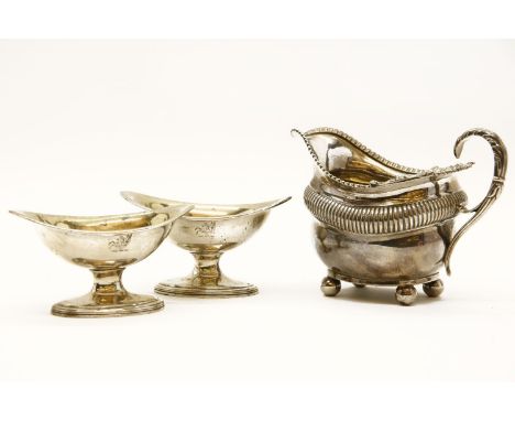 A pair of silver boat shaped salts, by Robert Hennell, London 1793, and a silver milk jug, by B.E London 1809, 12oz