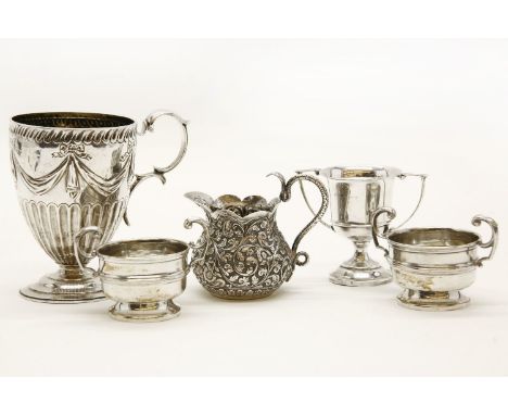 A Victorian silver christening mug, together with a small silver trophy, two silver handled vessels, and an Indian silver jug