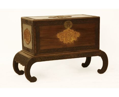 A Japanese carved camphorwood trunk and stand, early 20th century, 115cm wide x 48cm deep x 75cm high
