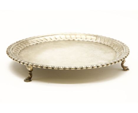 A small Georgian silver salver, by I.C, London 1770, on 3 hoof feet. 9oz. 17.5cm diam..