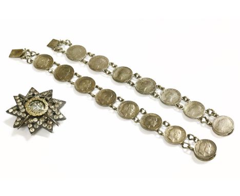 A Turkish silver military star, set with white paste stone, crossed swords with gold cased locket to centre, reading 'Veritas