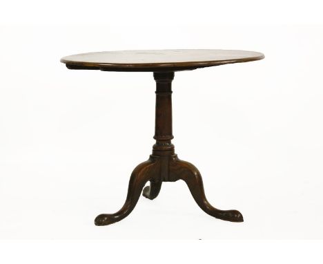 An oak tripod table, 18th century, with a circular top, a turned column on a tripod base, 87cm diameter