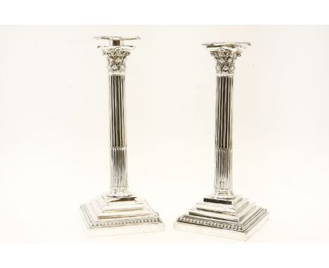 A pair of plated columnar candlesticks, William Hutton & Sons, Sheffield, circa 1900, each on stepped square base, fluted col