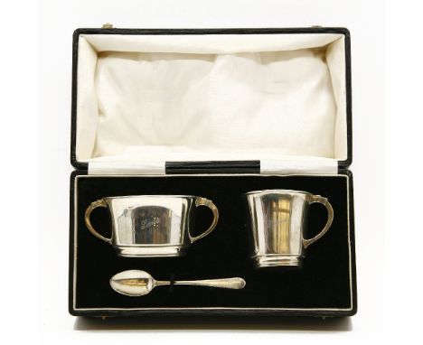 An Indian colonial silver christening set, in box, by Warner Brothers, Delhi, inscribed 'Sonia'. (spoon replaced)