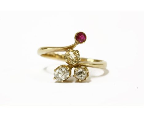 An Art Nouveau four stone ruby diamond and citrine ring, with a trefoil cluster of old European cut diamonds, all claw set to