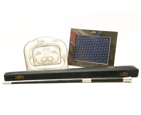 An early 20th century conductor's baton, with silver mounts, 52cm, cased, and two photograph frames