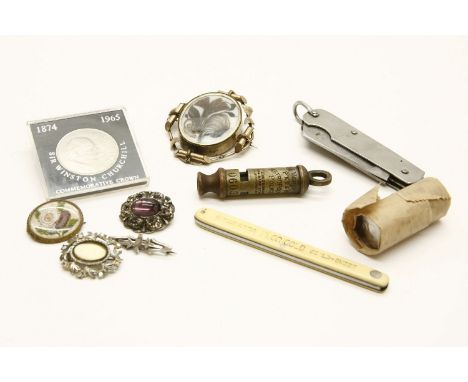 An assortment of items to include a Metropolitan police whistle, a military issue knife stamped SSP 1945, with the broad arro