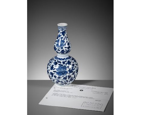 A BLUE AND WHITE DOUBLE GOURD VASE, KANGXI PERIODChina, 1662-1722. Of double gourd shape, with a flaring rim, painted in unde