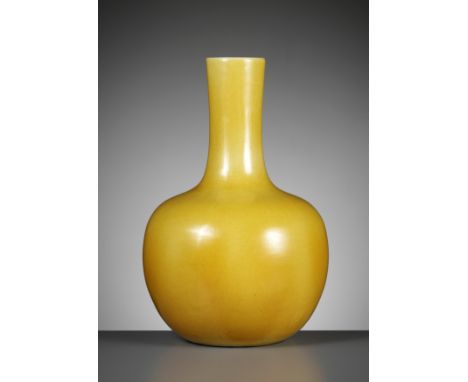 A MONOCHROME YELLOW-GLAZED BOTTLE VASE, TIANQIUPING, QING DYNASTYChina, 1644-1912. The globular body surmounted by a tall, sl