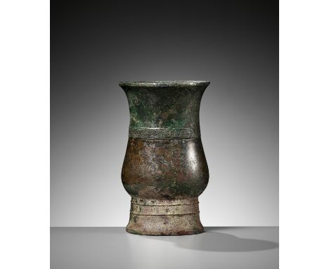 AN ARCHAIC BRONZE RITUAL WINE VESSEL, ZHI, LATE SHANG TO EARLY WESTERN ZHOU DYNASTYChina, ca. 1050 BC. Of elongated pear shap