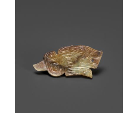 A TIGER-FORM JADE PENDANT, LATE SHANG DYNASTYChina, 13th-11th century BC. The crouching tiger carved in profile, the body wel