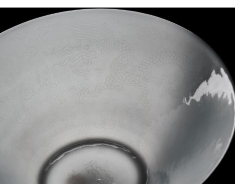 A RARE TIANBAI ANHUA-DECORATED 'DRAGON' BOWL, KANGXI PERIODChina, 1662-1722. Delicately potted, the deep conical sides suppor